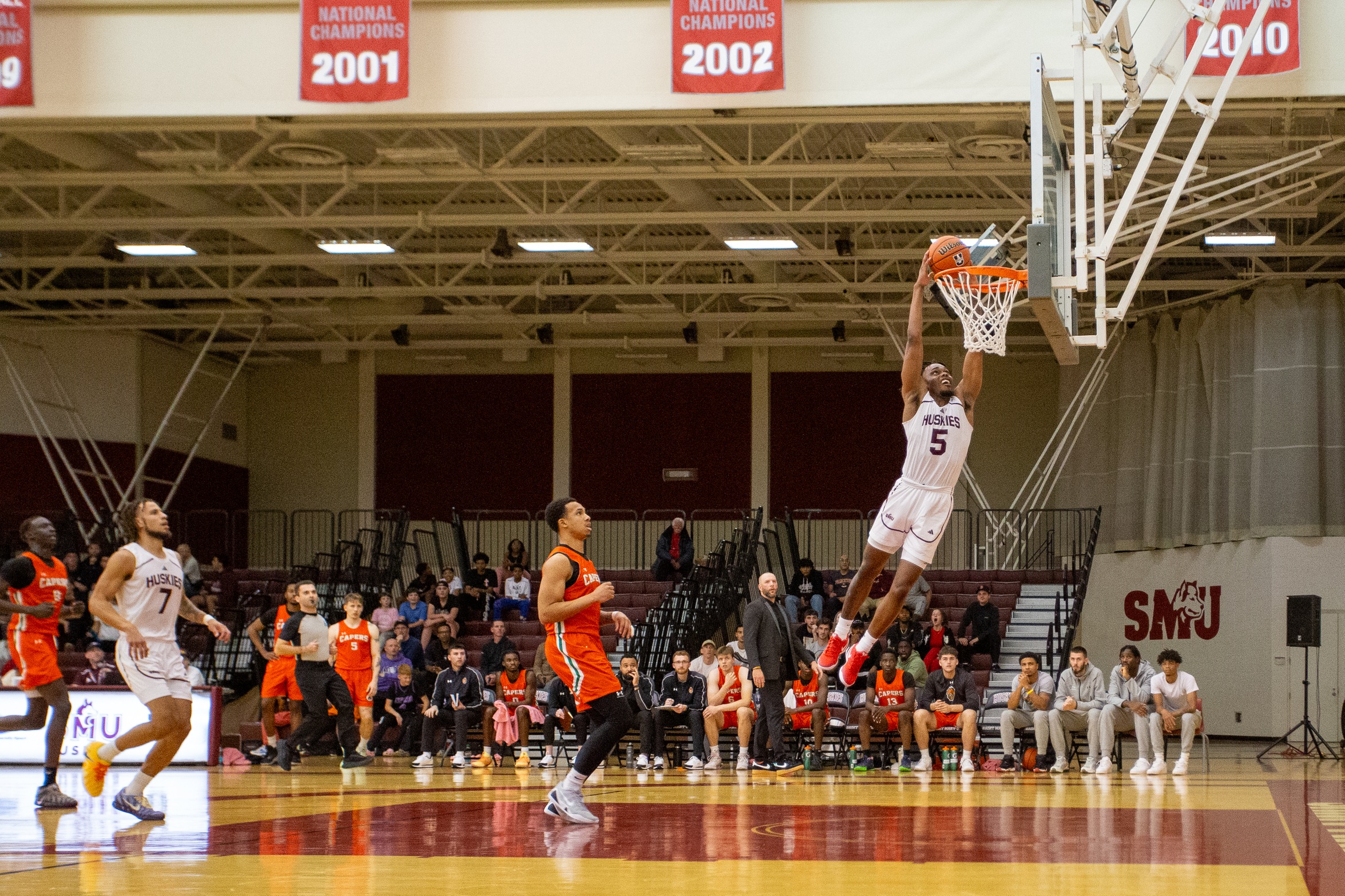 Capers defeat Huskies 79-77 in season-opening thriller
